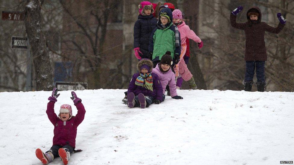 Children playing in the snow in Central Park, New York