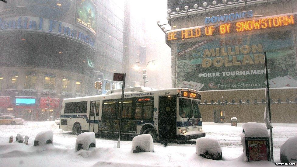 A bus makes its way through the snow in Times Square February 12, 2006 in New York City