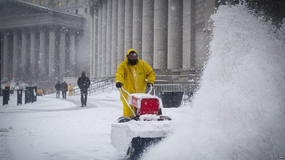 a man is using a machine to clear some snow