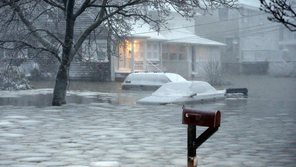 The streets are flooded with freezing water in Scituate, in Massachusetts.