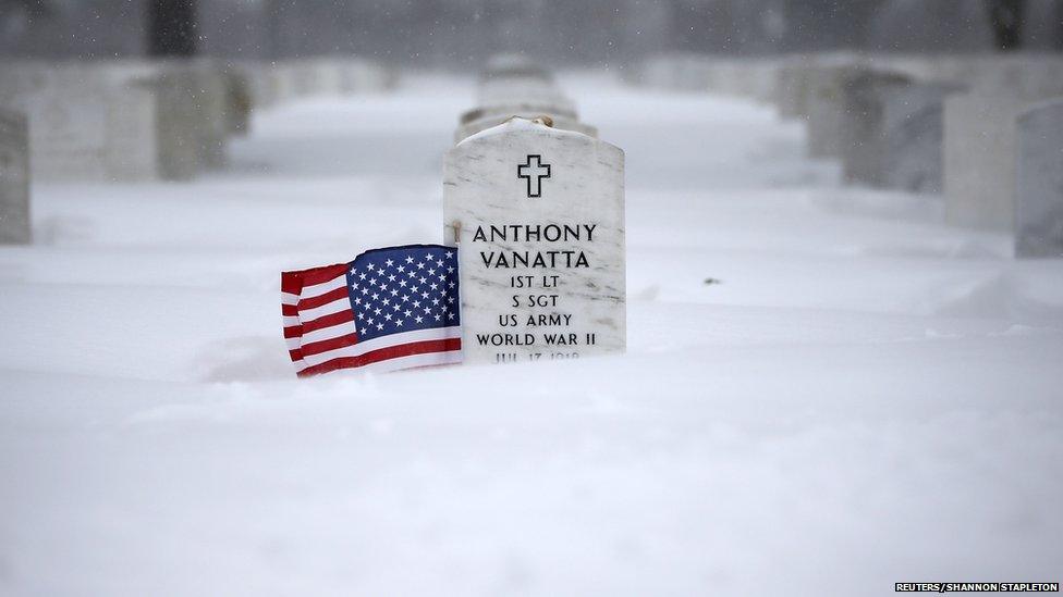 Snow is seen piled up on the graves of veterans at the Long Island National Cemetery in the Suffolk County area of Farmingdale, New York