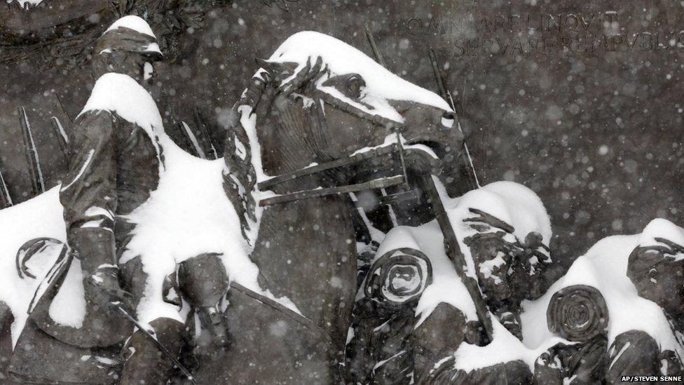 Snow accumulates on a Boston Common memorial honouring African-American Civil War soldiers from Massachusetts during a winter snowstorm Tuesday, Jan. 27, 2015