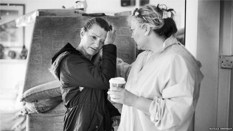 Penny Cotton comforts a patient, taken by Matilda Temperley