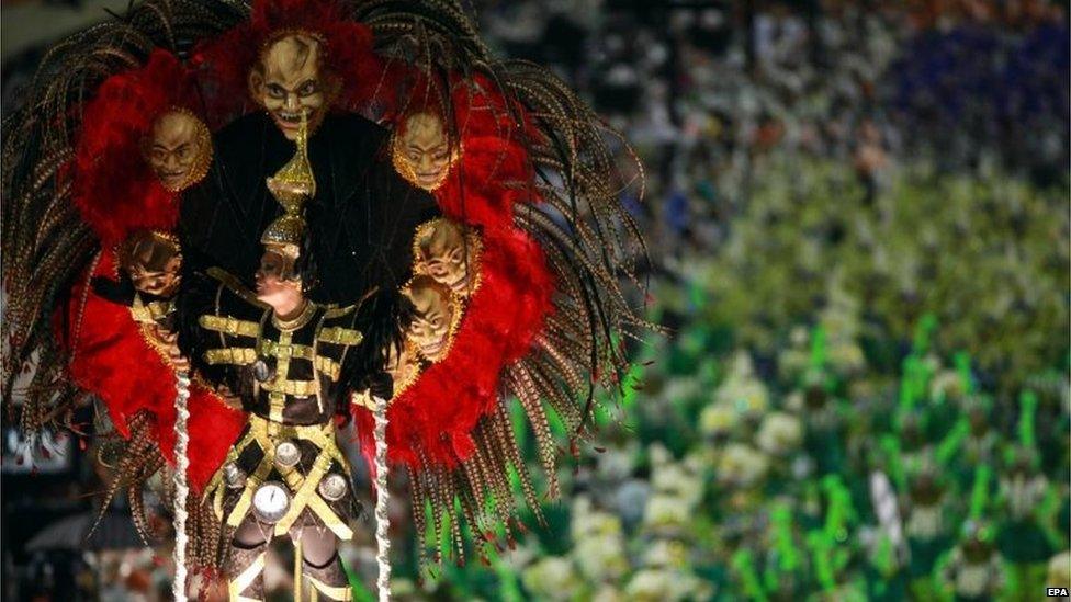 Members of the Samba Mocidade Independente de Padre Miguel troupe perform during the carnival parade in the streets of Rio de Janeiro on 15 February 2015.