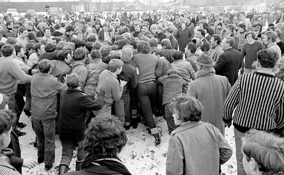 The ball is obscured in the 'hug' during the Shrovetide football game in Ashbourne 1969