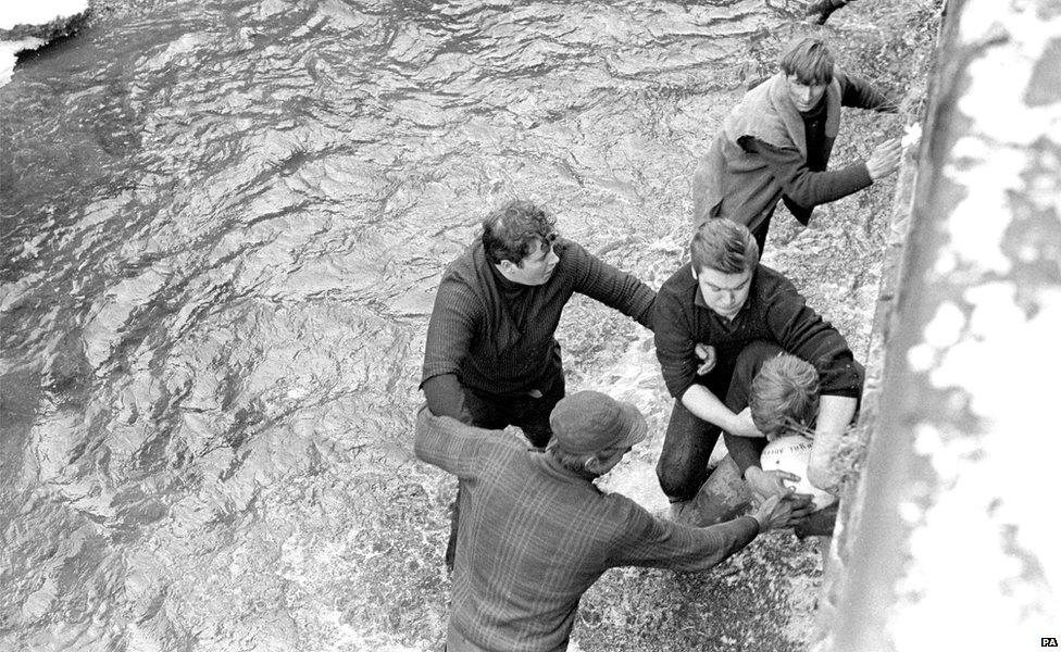 Competitors grapple for the ball in Henmore Brook during the Shrovetide football match in Ashbourne 1969