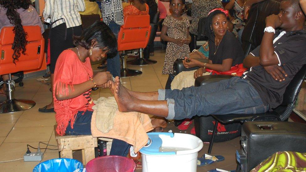 A pedicurist at work in Bruno's Place hair salon in Ikeja Mall in Lagos, Nigeria