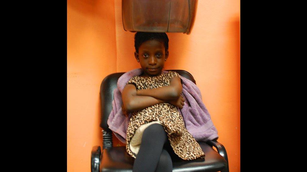 A child having her hair done at Bruno's Place hair salon in Ikeja Mall in Lagos, Nigeria