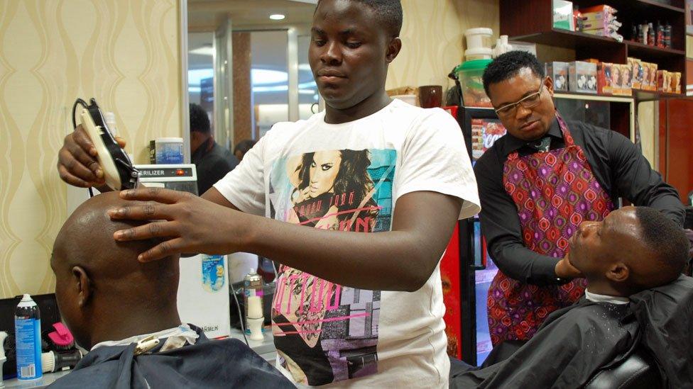 Barbers at work at Bruno's Place hair salon in Ikeja Mall in Lagos, Nigeria