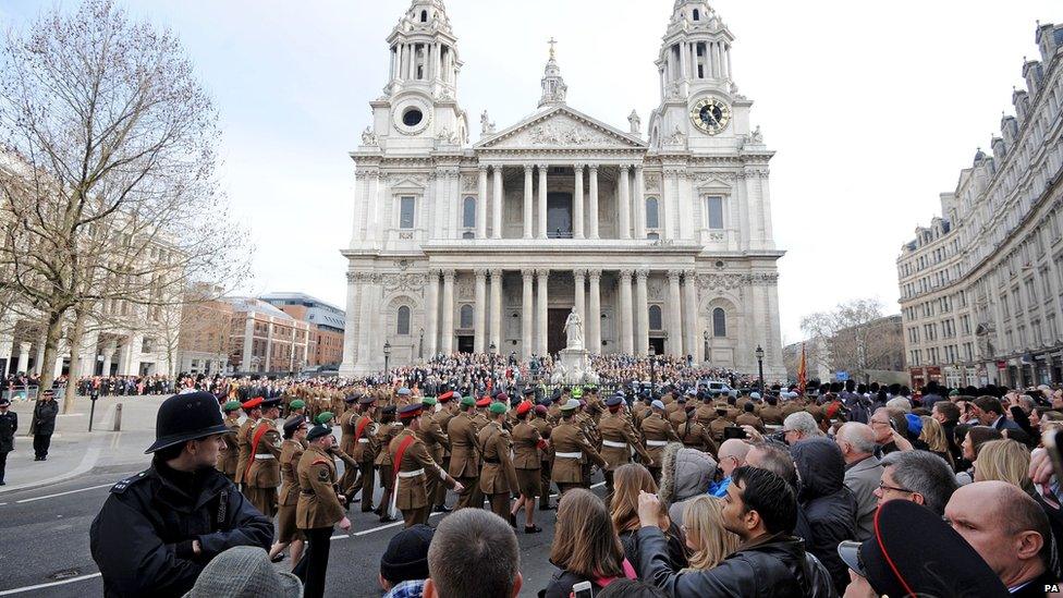 Members of the armed forces marching past St Paul's