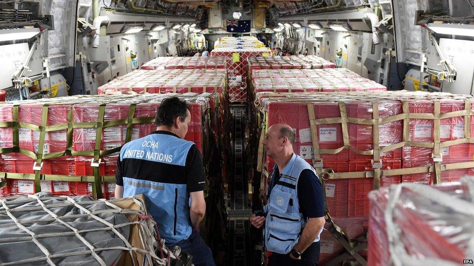 United Nations personnel are seen amongst aid being flown to Vanuatu's capital Port Villa onboard an RAAF C-17 Globemaster, 16 March 2015.