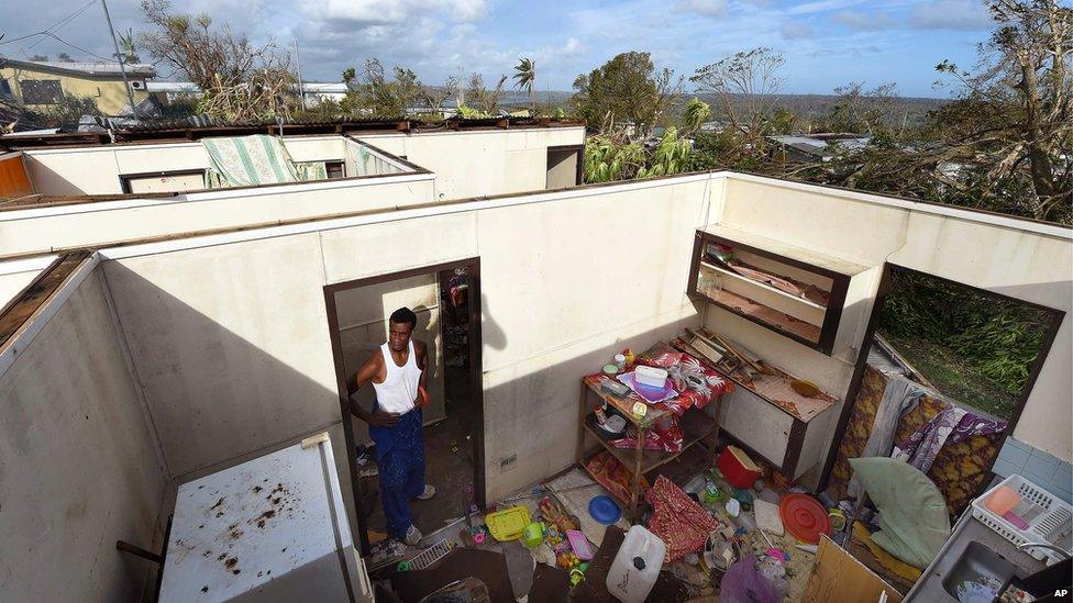 Uwen Garae surveys his damaged house in Port Vila, Vanuatu in the aftermath of Cyclone Pam Monday, 16 March 2015.