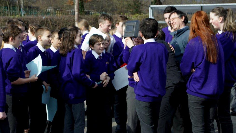 Schoolchildren watching solar eclipse