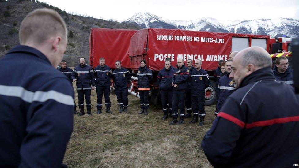 Firefighters and members of the emergency services meet at dawn