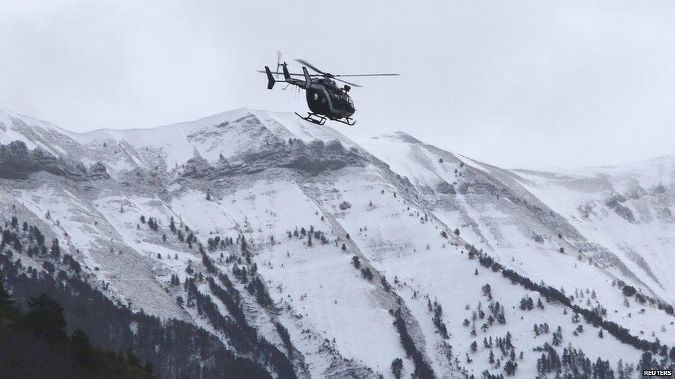 A rescue helicopter from the French Gendarmerie flies over the snow covered French Alps