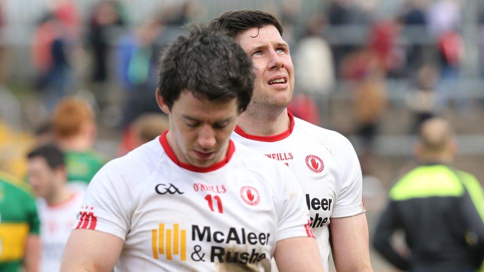 Dejected Tyrone duo Mattie Donnelly and Sean Cavanagh leave the Healy Park pitch after being held to a draw by Kerry which meant relegation to Division Two