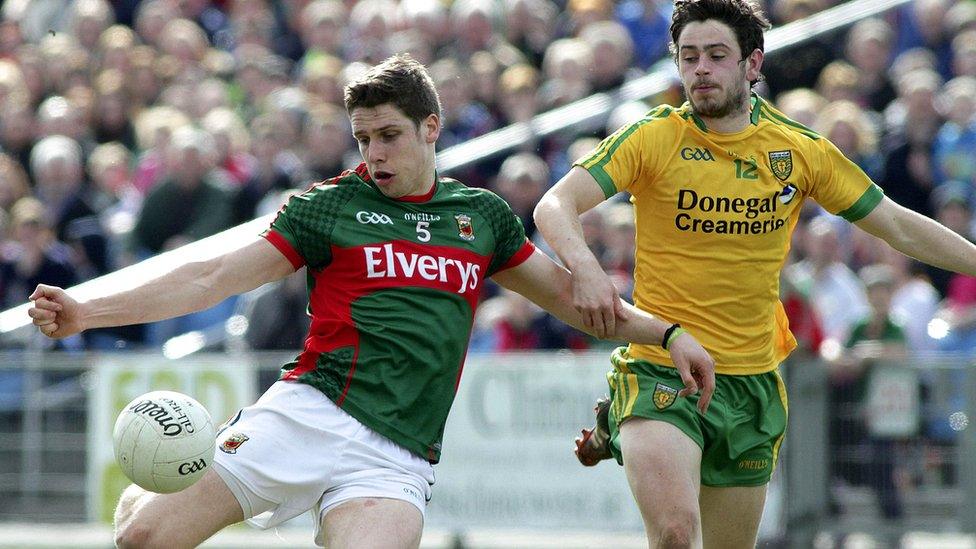 Mayo's Lee Keegan gets a shot in despite the efforts of Donegal opponent Ryan McHugh