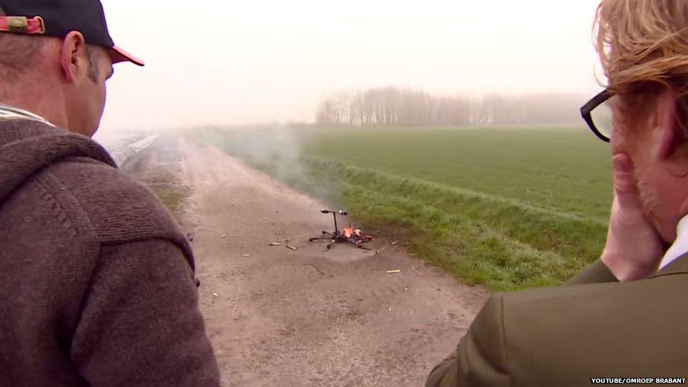 The team look on with horror as the drone burns.