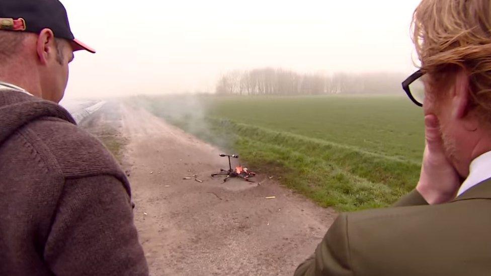 The team look on with horror as the drone burns.