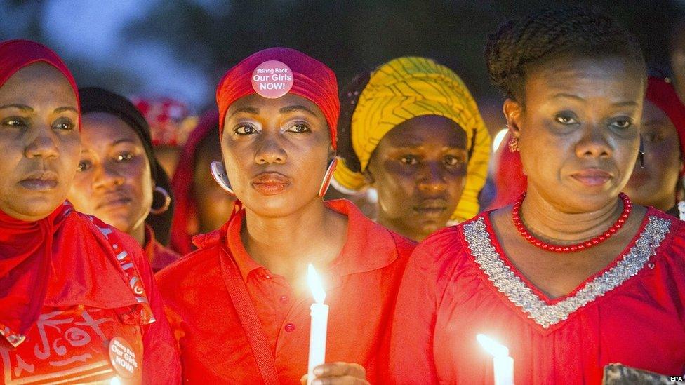 Nigerians hold candles during a vigil for the one year anniversary of the kidnapping of hundreds of Nigerian school girls in Chibok, Abuja, Nigeria, 14 April 2015