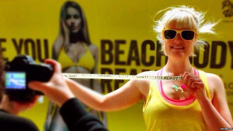 Woman standing with tape measure