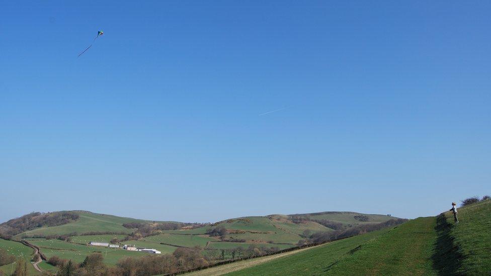 A boy flying a kite at a farm in Pontfaen, Brecon, in Powys.