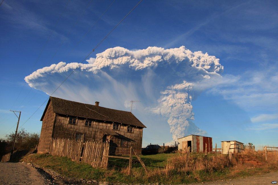 View from Puerto Montt, southern Chile, of a high column of ash and lava spewing from the Calbuco volcano, 22 April 2015.