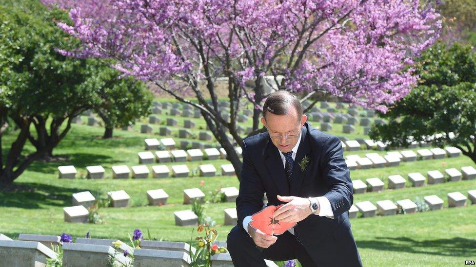 Australian Prime Minister Tony Abbott reads a message left at the Shrapnel Valley cemetery near Gallipoli