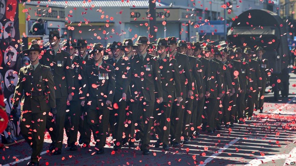 Soldiers march through a sea of poppies during a street parade to commemorate Anzac Day in Wellington, New Zealand