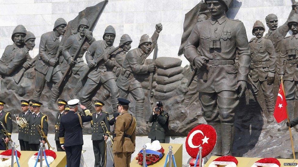 Britain's Prince Charles salutes in front of the memorial in Abide