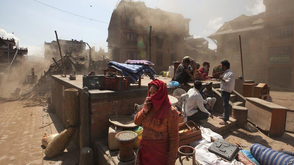 Nepalese residents gather in an open space at the site of destruction caused after Saturday's earthquake in Bhaktapur, on the outskirts of Kathmandu (27 April 2015)