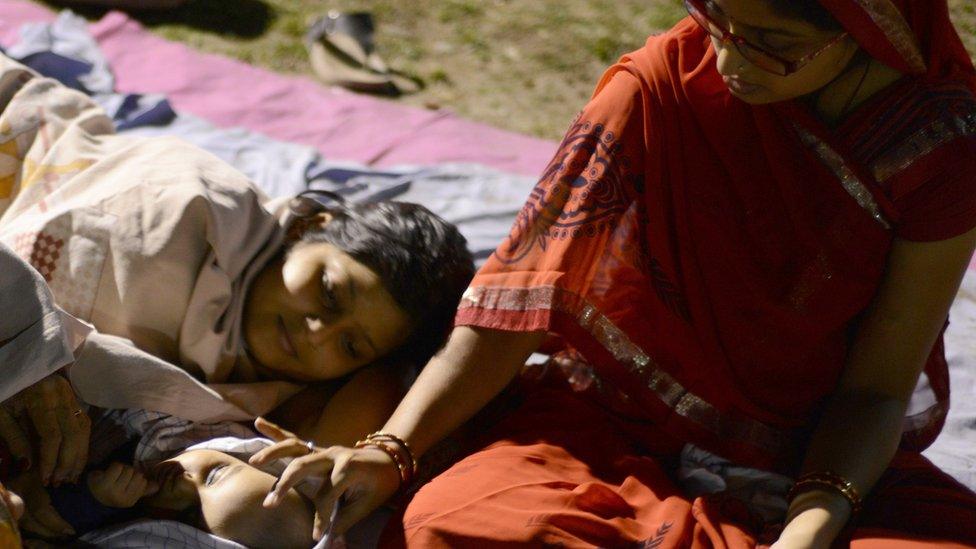 Indian residents rest and sleep in a football field in Siliguri on April 26, 2015 after a 7.8 magnitude earthquake hit the region on April 25 in Nepal.