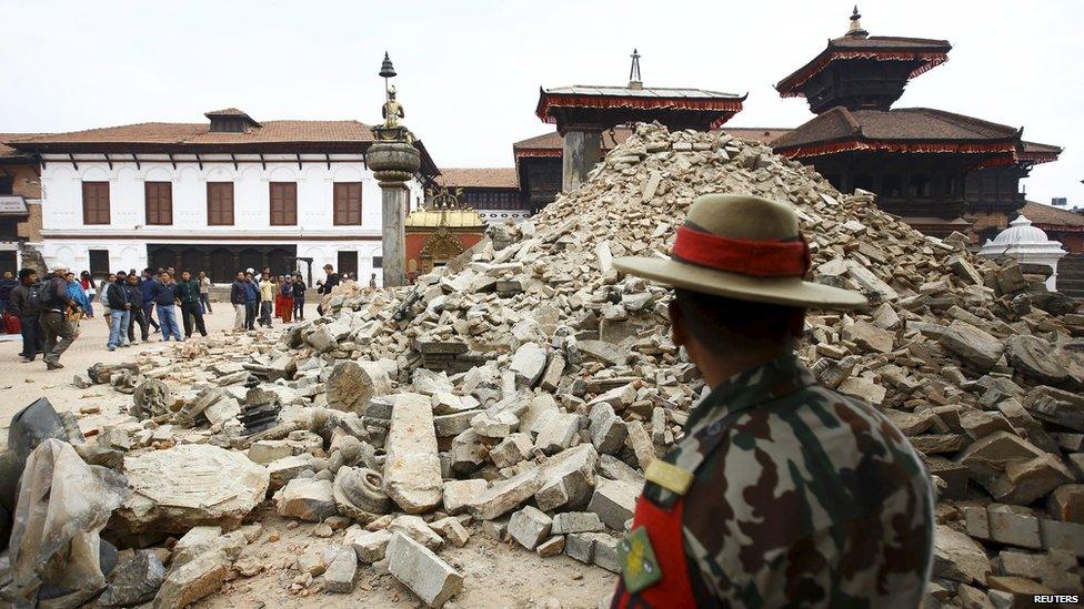 A Nepalese army personnel stands in front of a collapsed temple a day after an earthquake in Bhaktapur, Nepal (April 26, 2015)