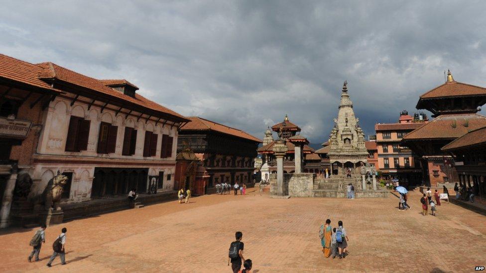 Nepalese pedestrians pass through Bhaktapur Durbar Square in Bhaktapur (July 21, 2011)