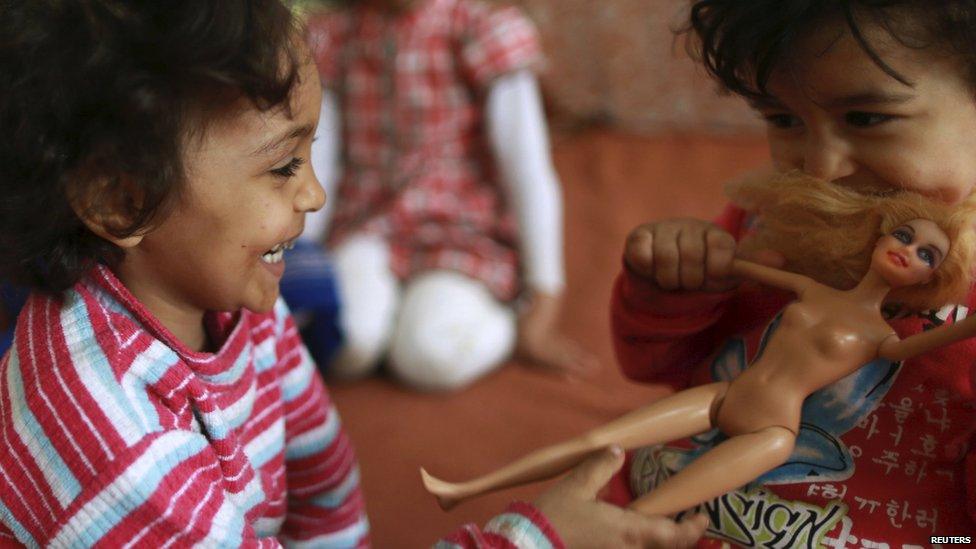Displaced girls playing with a doll in Benghazi, Libya - Thursday 30 April 2015