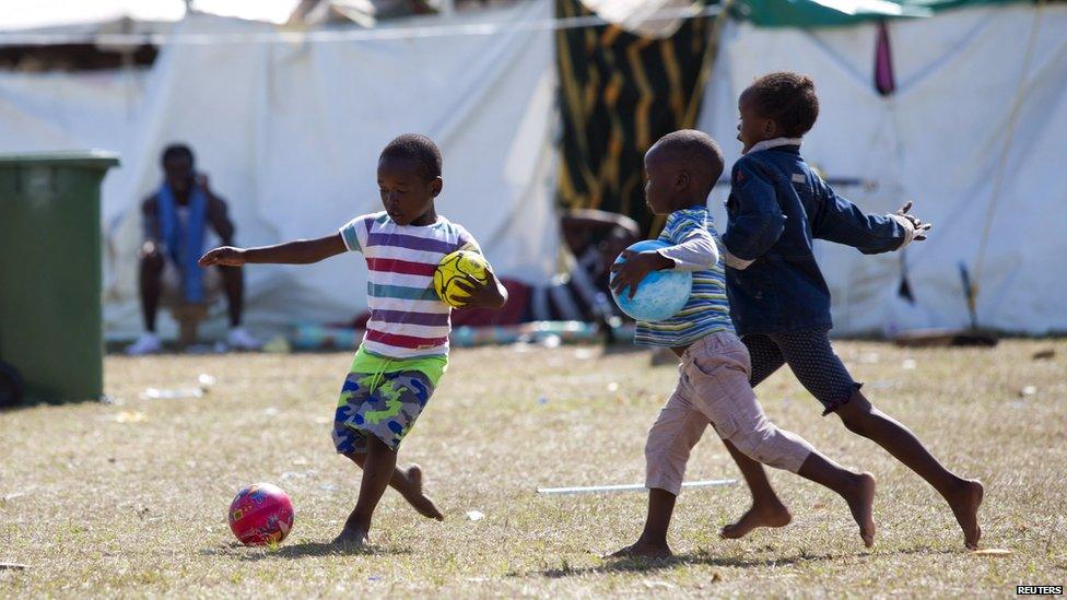 Children play football in a displacement camp in Isipingo, South Africa - Saturday 25 April 2015