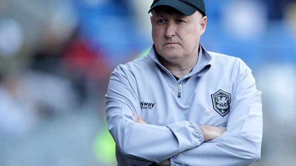 Russell Slade looks on with folded arms at the Cardiff City Stadium