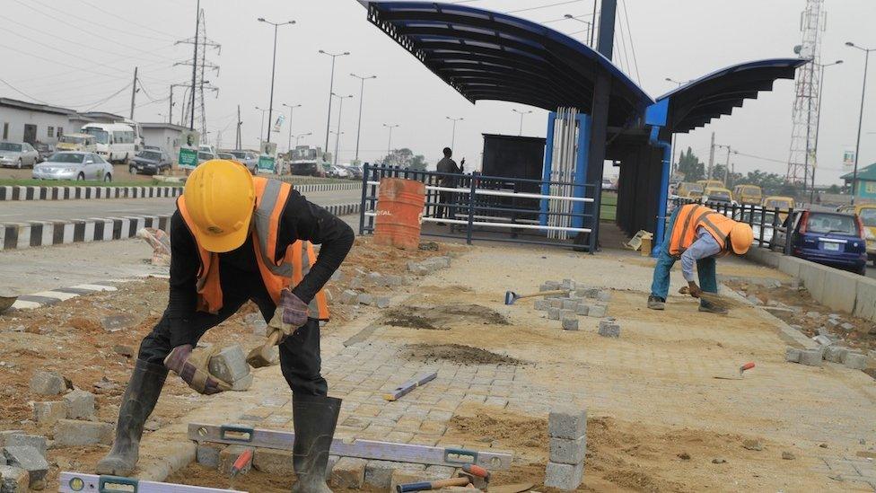 Workers at a construction site for a new bus station in Lagos, Nigeria