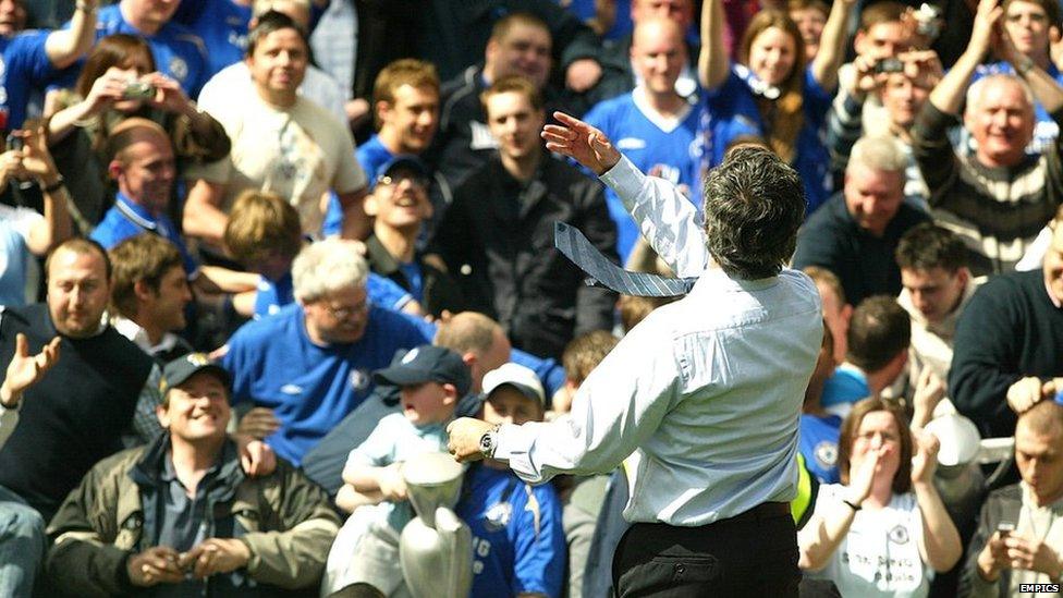 Jose Mourinho throws his winner's medal into the crowd