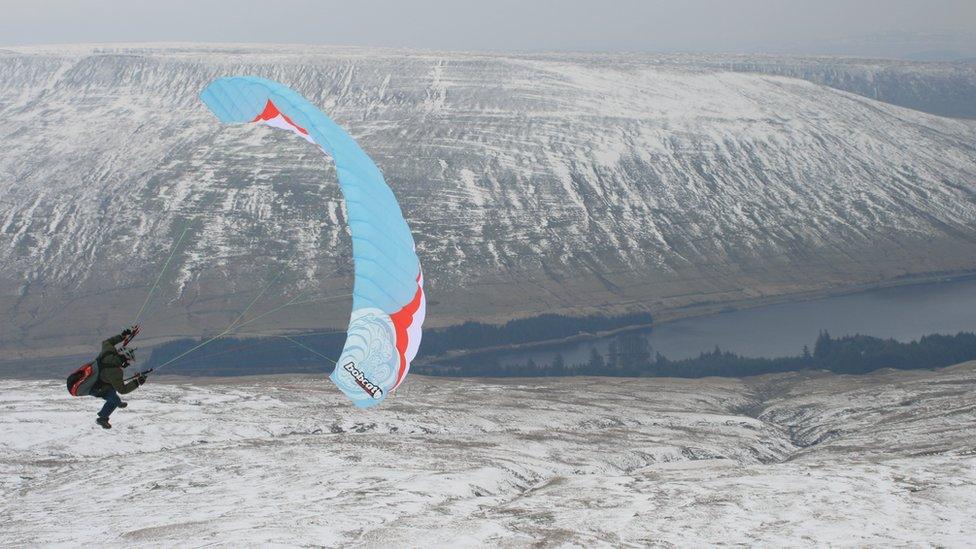 This pictures from Fan Fawr looking towards Beacons reservoir of a paraglider having fun on a very cold day was taken by Phil Maurice