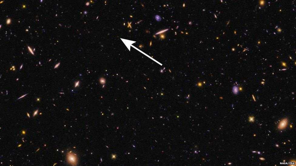 A tiny speck among larger galaxies shows the location of EGS-zs8-1.