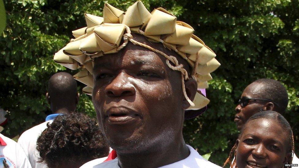 Supporters of Togo's President Faure Gnassingbe look on as the results of the presidential election is announced in Lome 3 May 2015