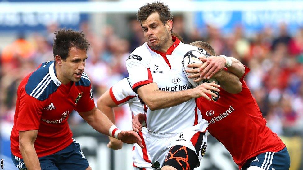 Ulster fullback Louis Ludik's break is thwarted by Munster wing Keith Earls