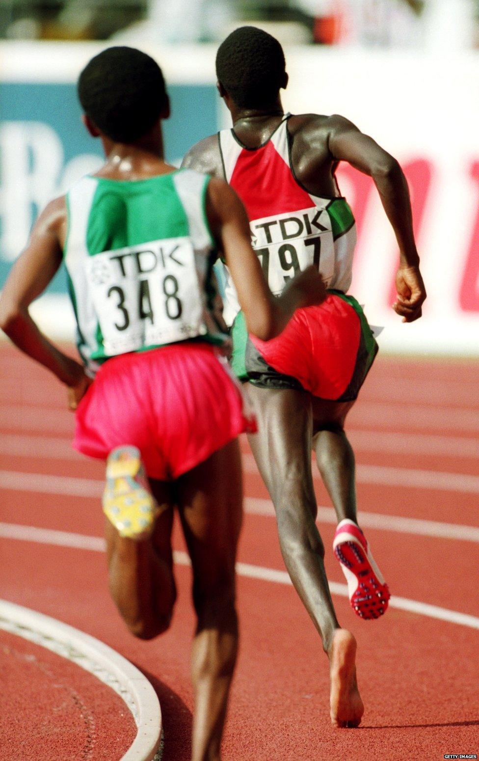 STUTTGART - AUGUST 22: Moses Tanui of Kenya wearing one running spike sprints clear of Haile Gebrselassie of Ethiopia during the 10,000 metres final at the IAAF World Championships held on August 22, 1993 at the Gottlieb-Daimler Stadium, in Stuttgart, Germany. Tanui lost one of his running spikes after having his heel clipped by Gebrselassie during the final lap sprint finish.