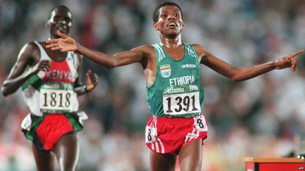 Ethiopia's Haile Gebreselassie celebrates as he crosses the finish line of men's10,000m race ahead of Kenyan Paul Tergat 29 July at the Olympic Stadium in Atlanta. Gebreselassie won the event in a time of 27min 07.34 sec, a new Olympic record, beating Paul Tergat and Salah Hissou of Morocco