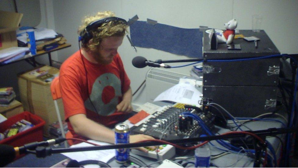 Huw Stephens y tu ôl i ddesg ddarlledu C2, 鶹Լ Radio Cymru yn Eisteddfod Meifod 2003