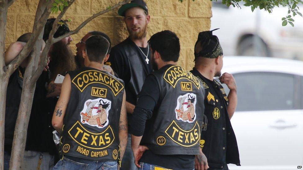 Gang members standing around after the shootout