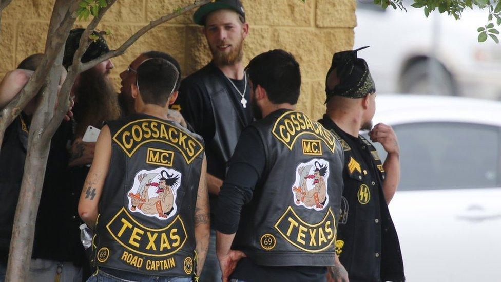 Gang members standing around after the shootout