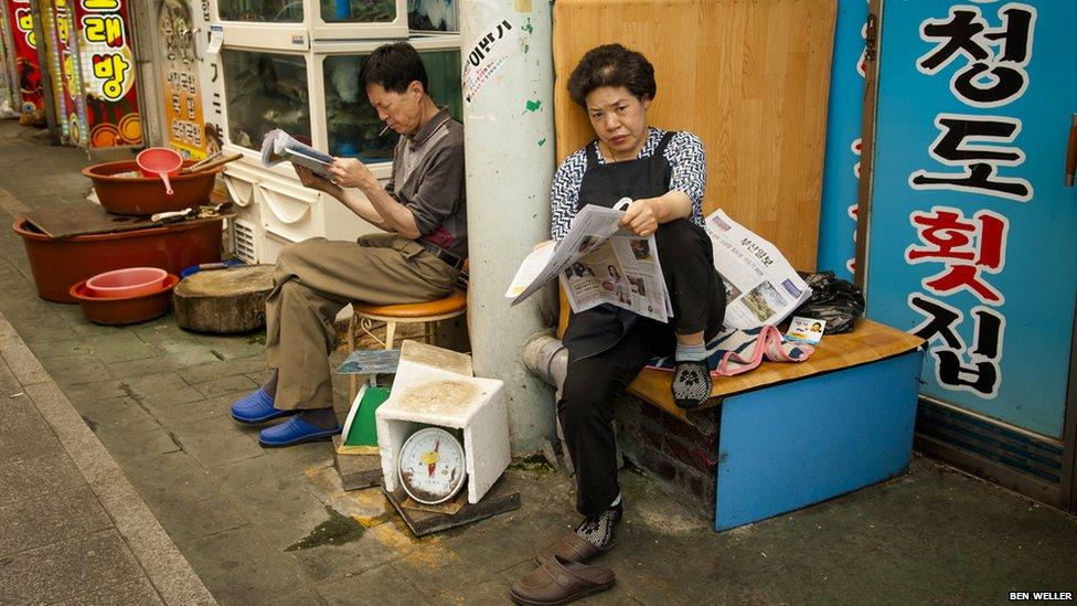 A pair of market traders waiting for market to open.