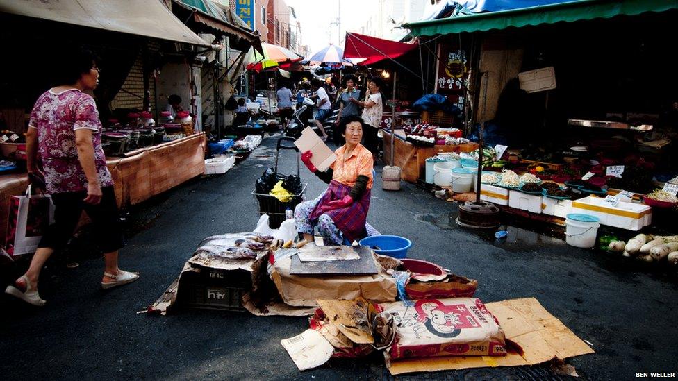 A fish vendor at Deokpo market in Busan.